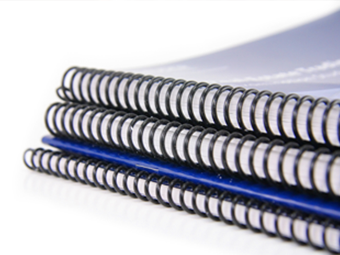 Stack of manuals with spiral binding